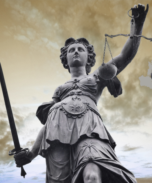 Statue of Lady Justice holding scales and a sword, symbolizing fairness and justice against a cloudy sky backdrop